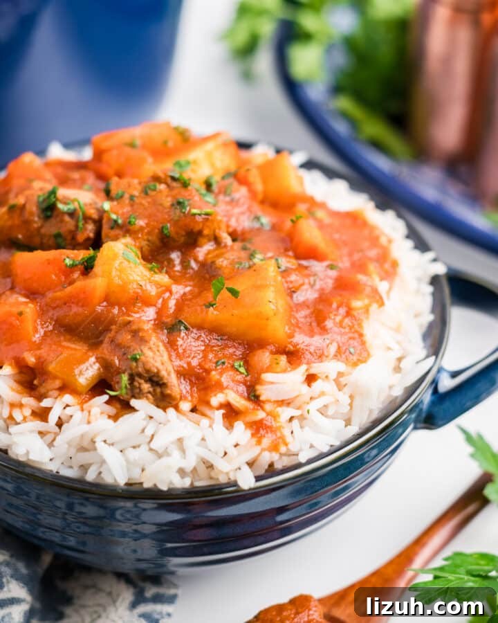 Hawaiian beef stew in a bowl over rice.