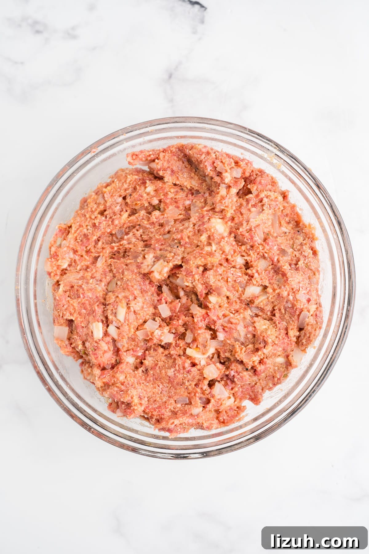 All the Italian meatloaf ingredients mixed in a bowl.