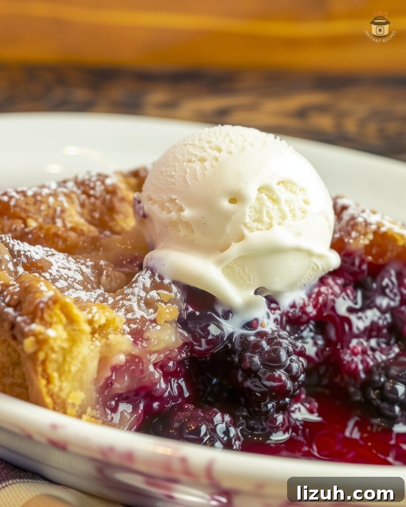 golden-brown blackberry cobbler with a scoop of vanilla ice cream