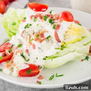 Classic Wedge Salad Recipe with Creamy Blue Cheese Dressing 8 wedge salad with blue cheese dressing tomatoes and bacon on a plate