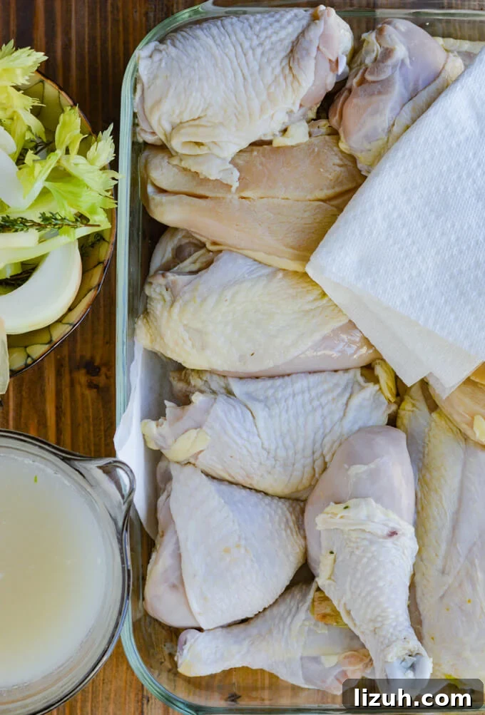 Raw chicken pieces with a paper towel, bowl of celery and onions, and a bowl of wine marinade.