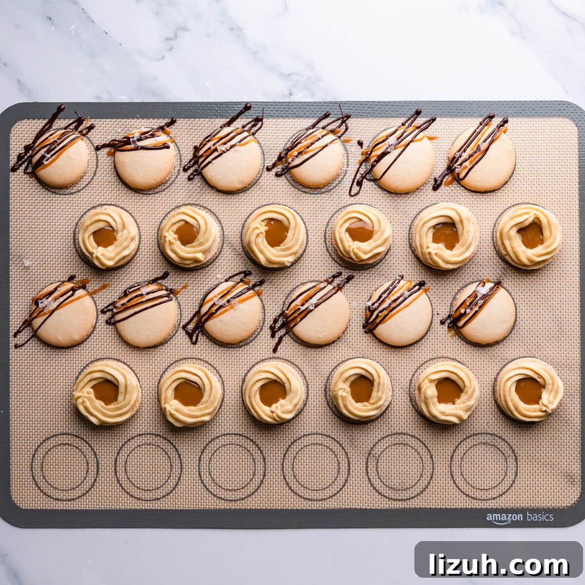 Irresistible Salted Caramel Macarons Recipe for Perfect Results 11 salted caramel macarons shells with chocolate and caramel drizzle and buttercream filling.