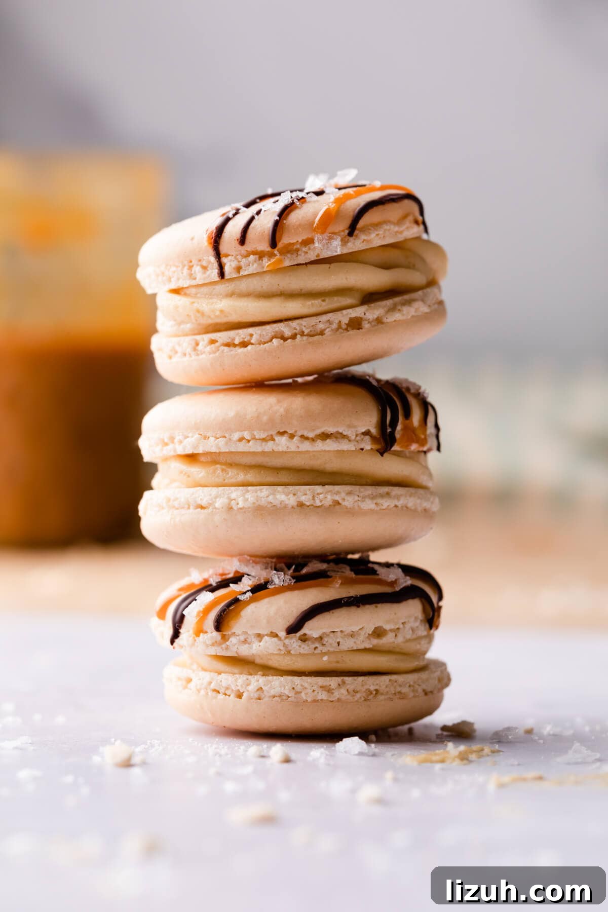 Irresistible Salted Caramel Macarons Recipe for Perfect Results 12 three salted caramel macarons stacked on top of each other.