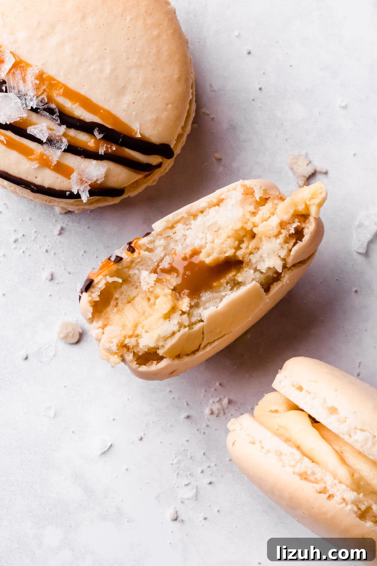Irresistible Salted Caramel Macarons Recipe for Perfect Results 15 an individual macaron with bite taken out of it filled with caramel and buttercream.
