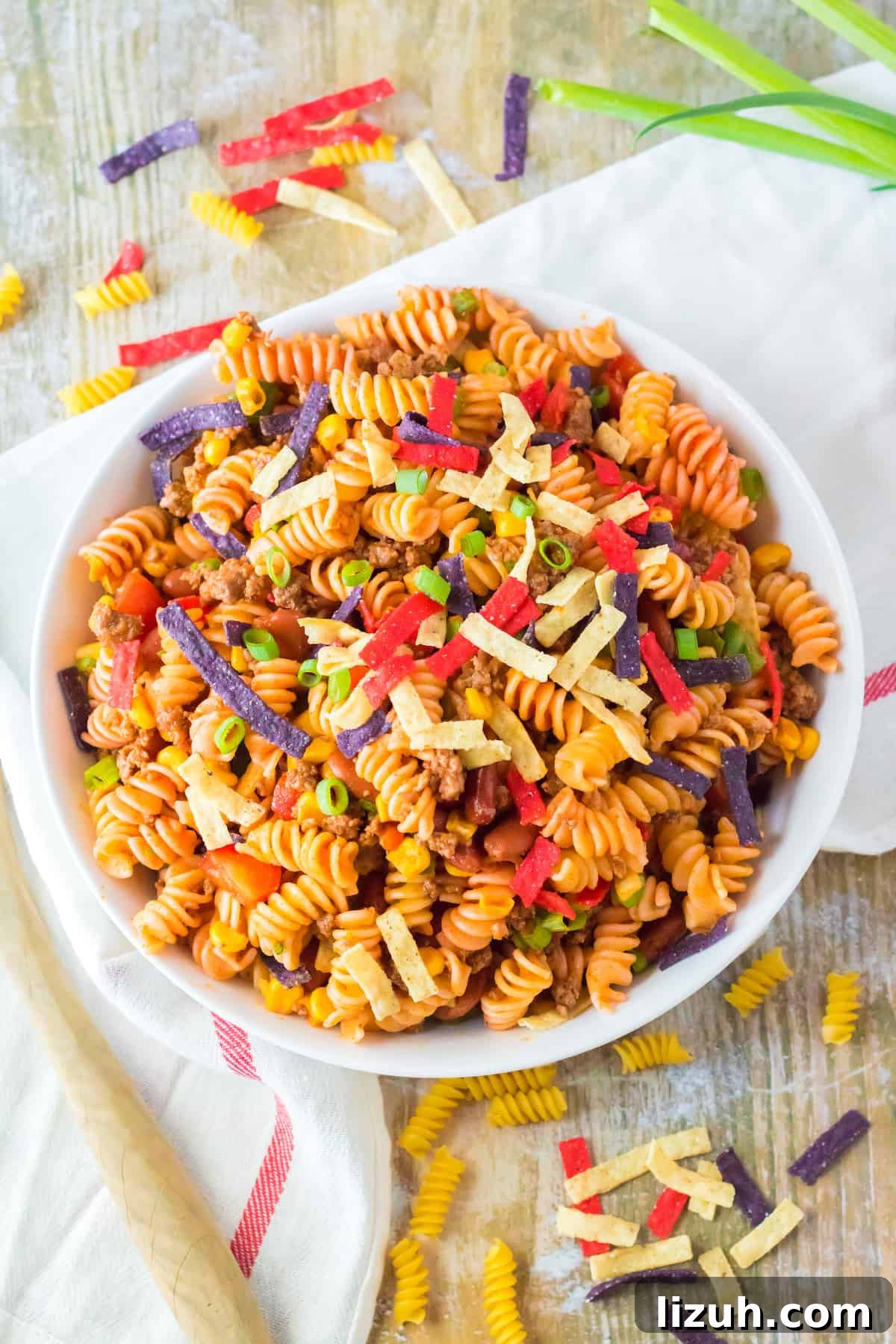 Spiral shaped pasta topped with tortilla strips.