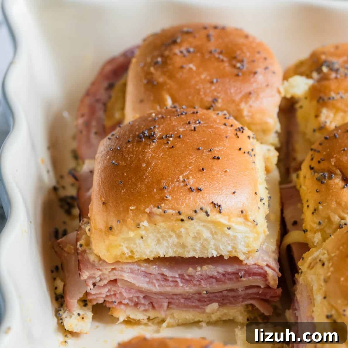 Ham and cheese funeral sandwiches layered in baking dish ready to bake.