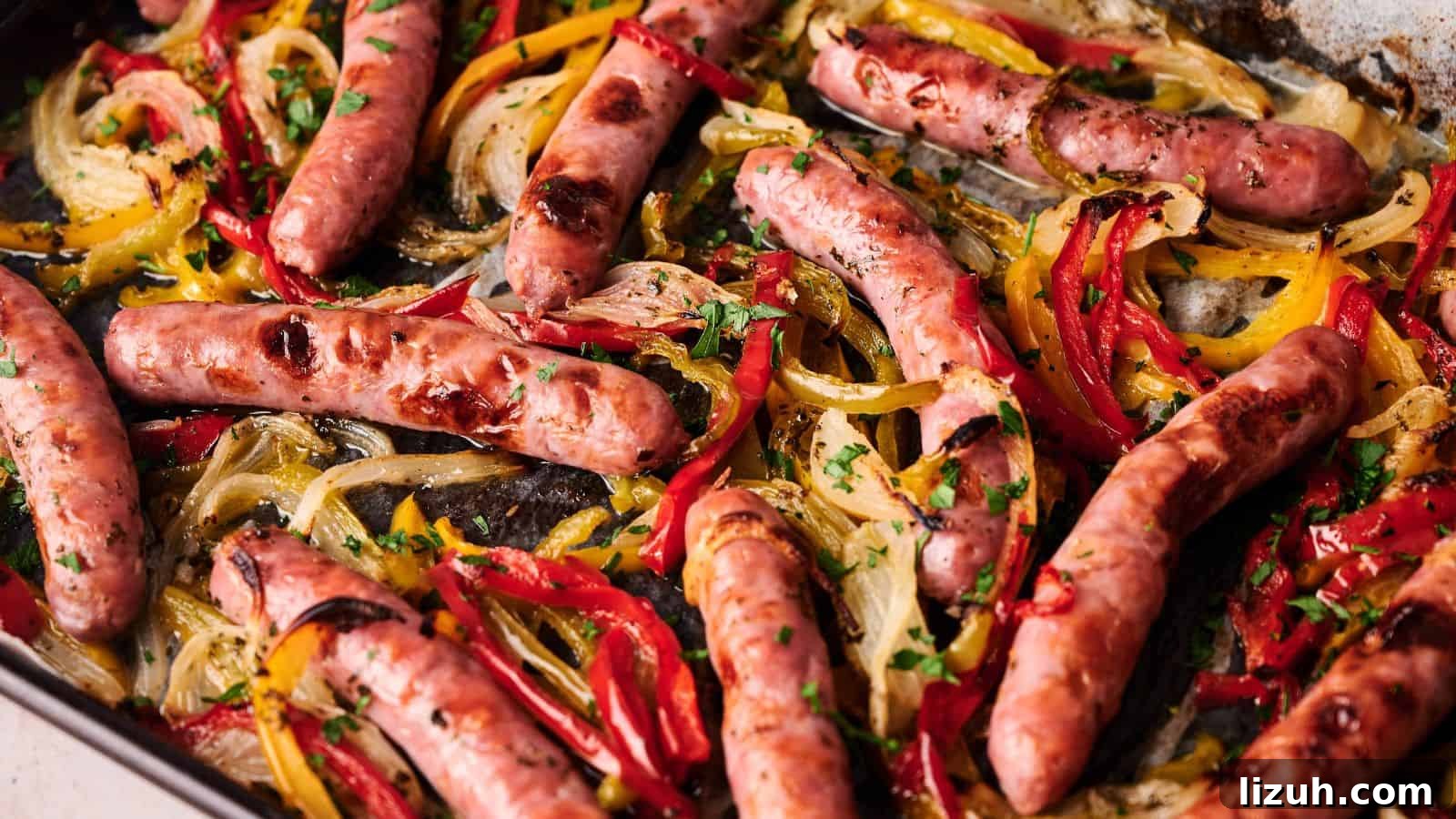 35 Game-Day Recipes to Win Your Season’s Food Lineup 12 Sheet pan with roasted sausages, sliced red and yellow bell peppers, and onions, garnished with chopped parsley.