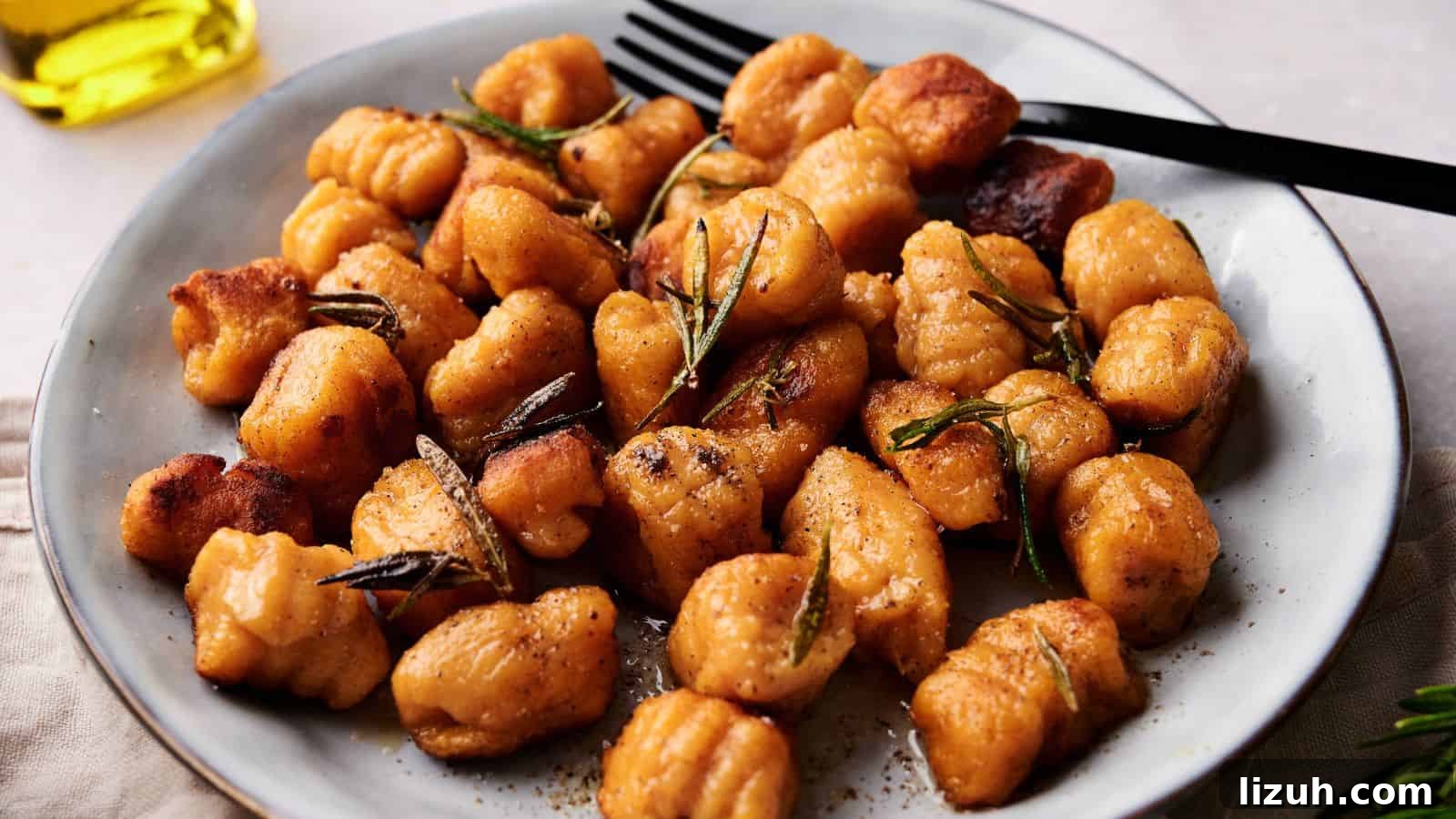35 Game-Day Recipes to Win Your Season’s Food Lineup 4 A plate of golden-brown gnocchi garnished with rosemary, served with a black fork.