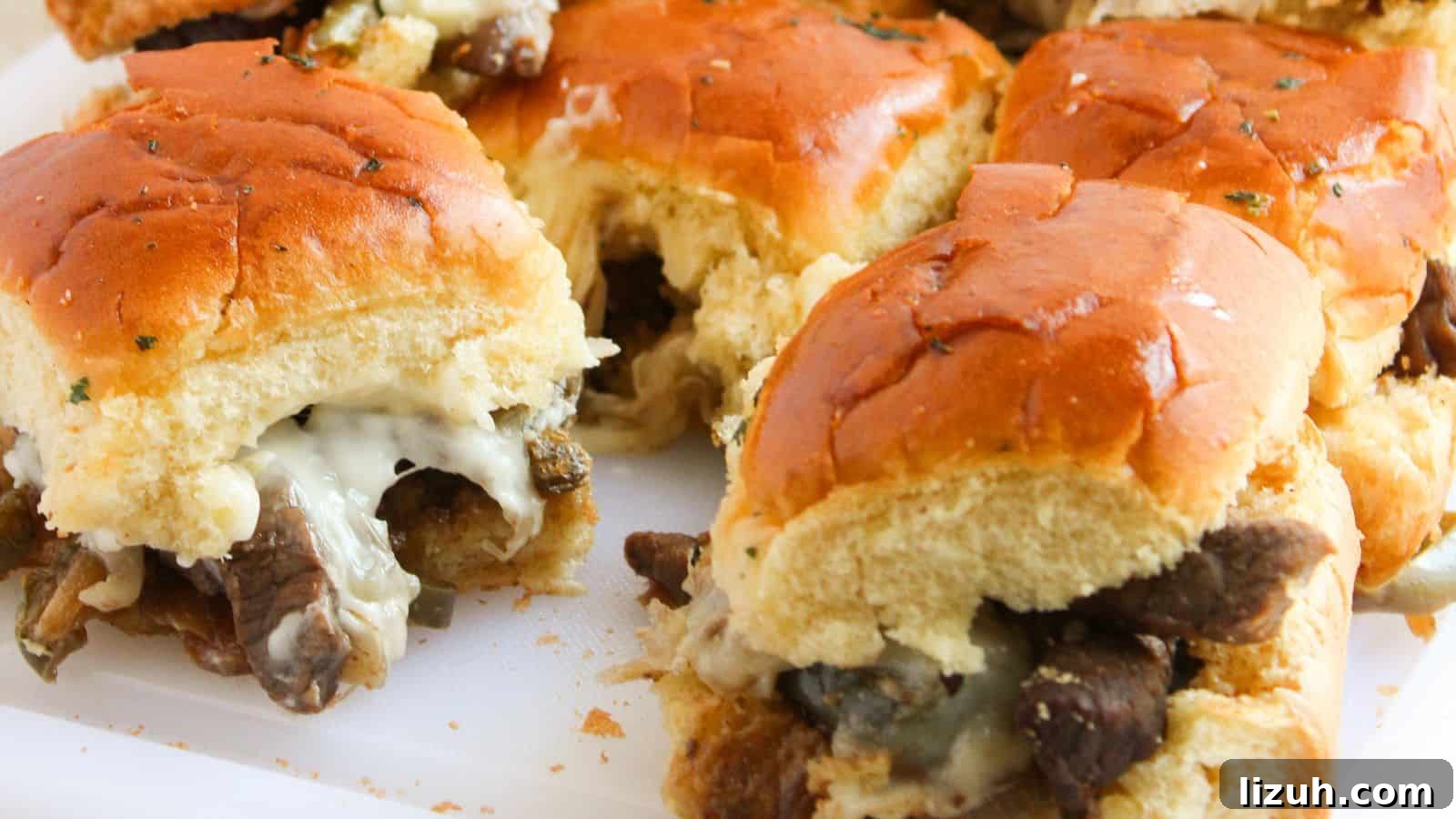 35 Game-Day Recipes to Win Your Season’s Food Lineup 31 Close-up of beef and cheese sliders with toasted buns on a white surface.