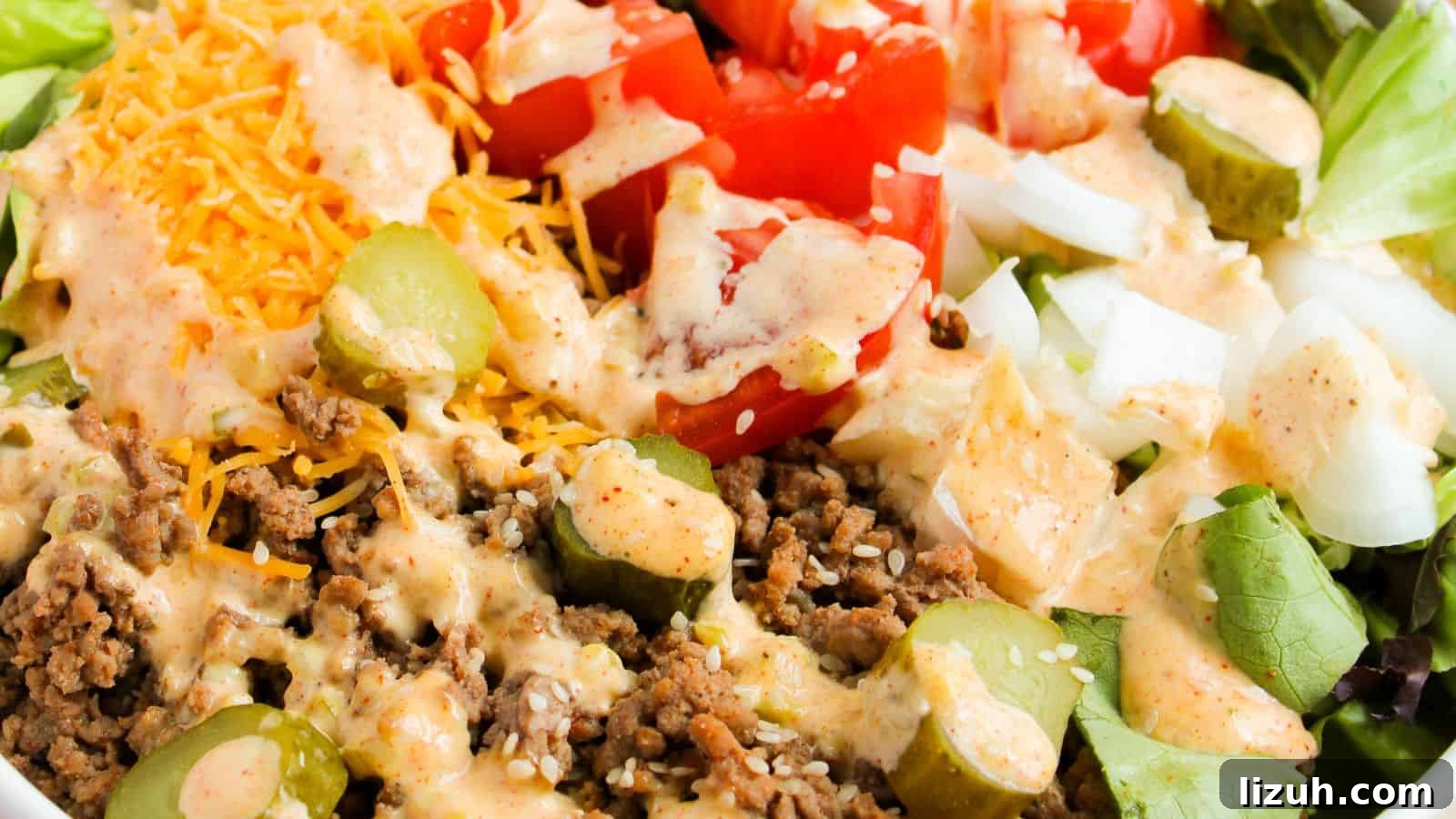 35 Game-Day Recipes to Win Your Season’s Food Lineup 35 Close-up of a salad featuring ground beef, sliced pickles, diced tomatoes, shredded cheese, and diced onions, topped with a creamy dressing.