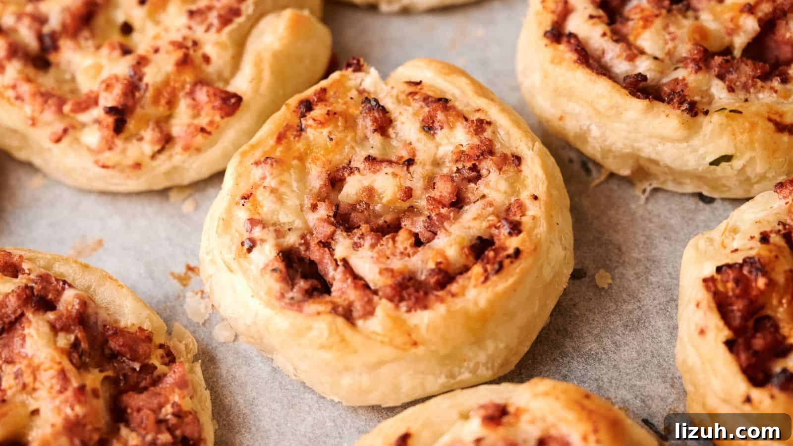 35 Game-Day Recipes to Win Your Season’s Food Lineup 37 Close-up of several baked puff pastry pinwheels filled with minced meat, arranged on a baking tray lined with parchment paper.