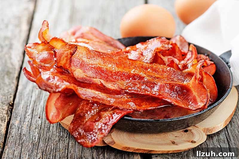 9 Delicious Tricks to Boost Flavor in Steamed Vegetables 10 Horizontal image of cooked crispy bacon in a small skillet.