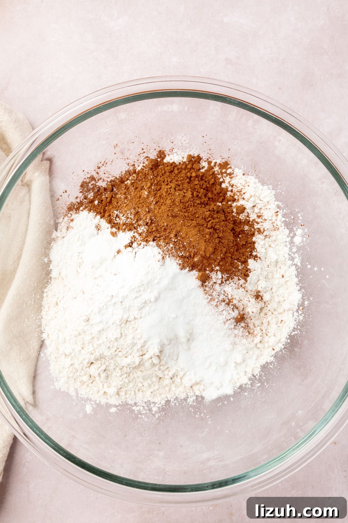 Gluten-Free Red Velvet Cake Recipe: Moist, Rich & Simple to Make 5 Gluten-free flour, cocoa powder, cornstarch, baking powder, and baking soda in a glass mixing bowl.