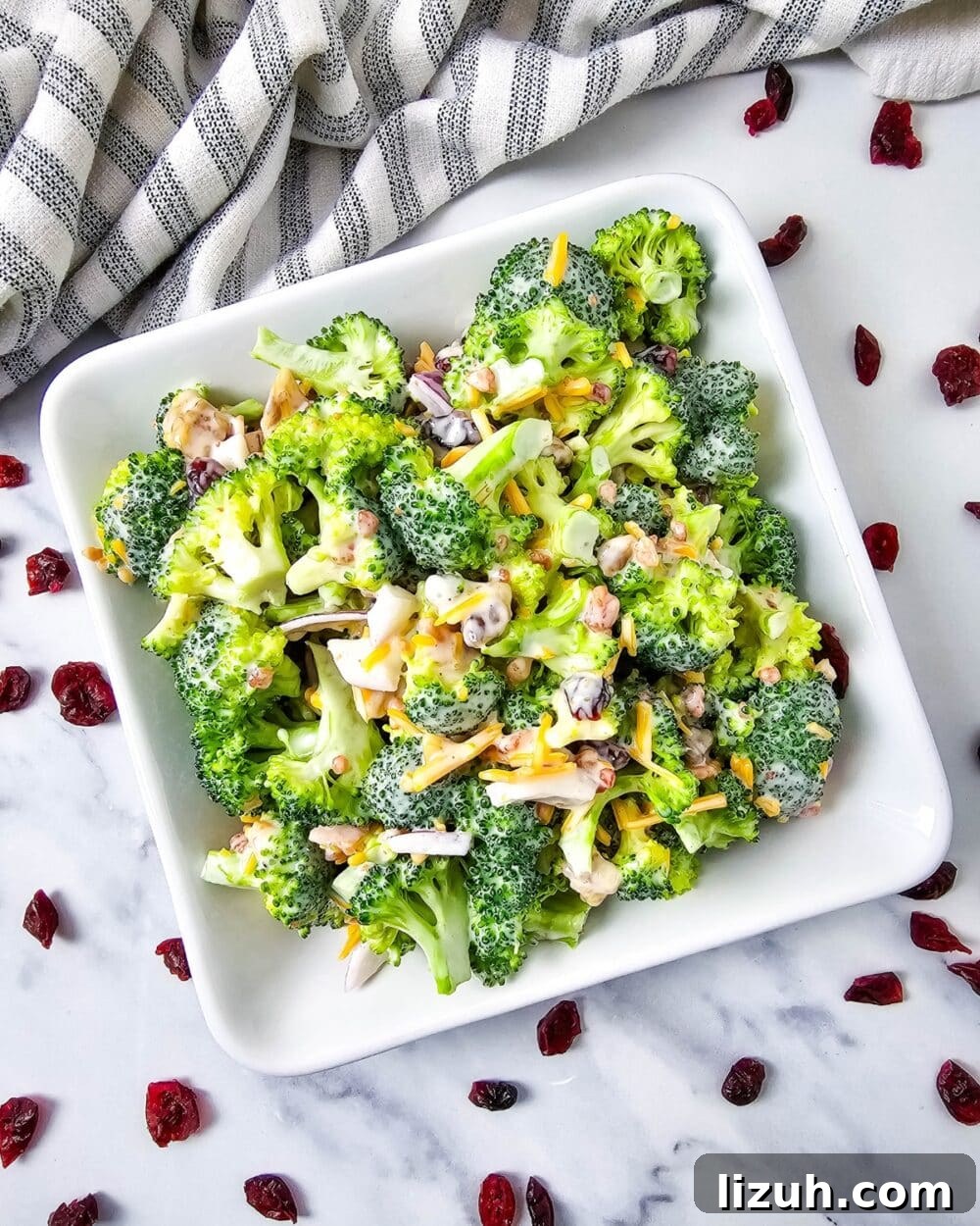 Keto Broccoli Salad with Bacon, Cheddar & Creamy Dressing 2 Low Carb Broccoli Salad in a bowl with cranberries scattered