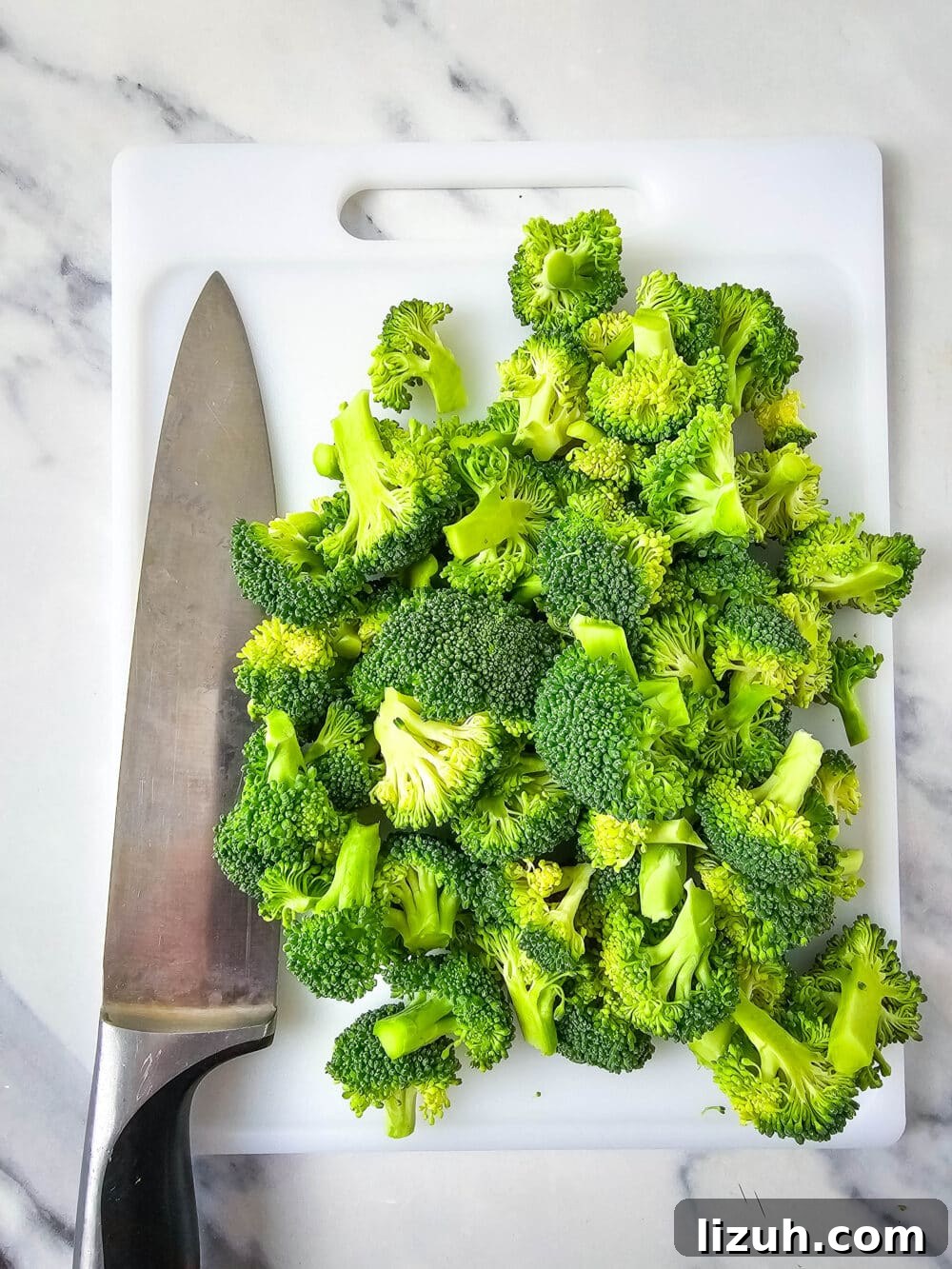 Keto Broccoli Salad with Bacon, Cheddar & Creamy Dressing 4 chopped broccoli with knife nearby