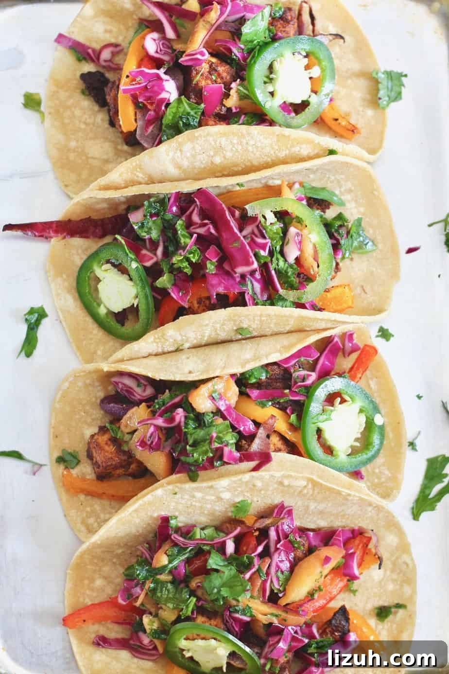 Zesty Tofu Tacos with Peaches and Crunchy Cabbage Slaw 2 Change the tofu game with these delicious Zesty Sheet Pan Tofu Tacos with Peach Kale Slaw! A fresh, flavorful, wholesome meal the entire family will devour. Vegan + gluten-free.