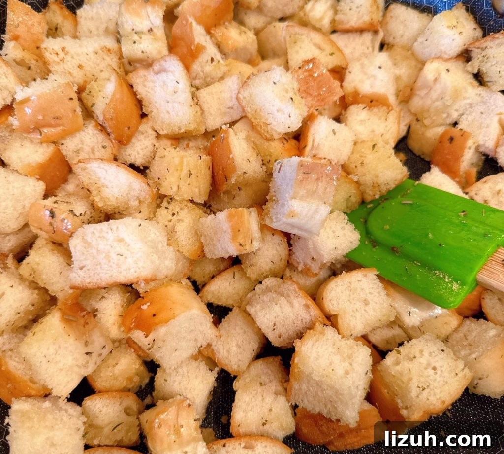 Skillet Croutons from Scratch: Crispy Homemade Recipe 5 Cubed bread in a hot skillet being toasted with seasoned olive oil.