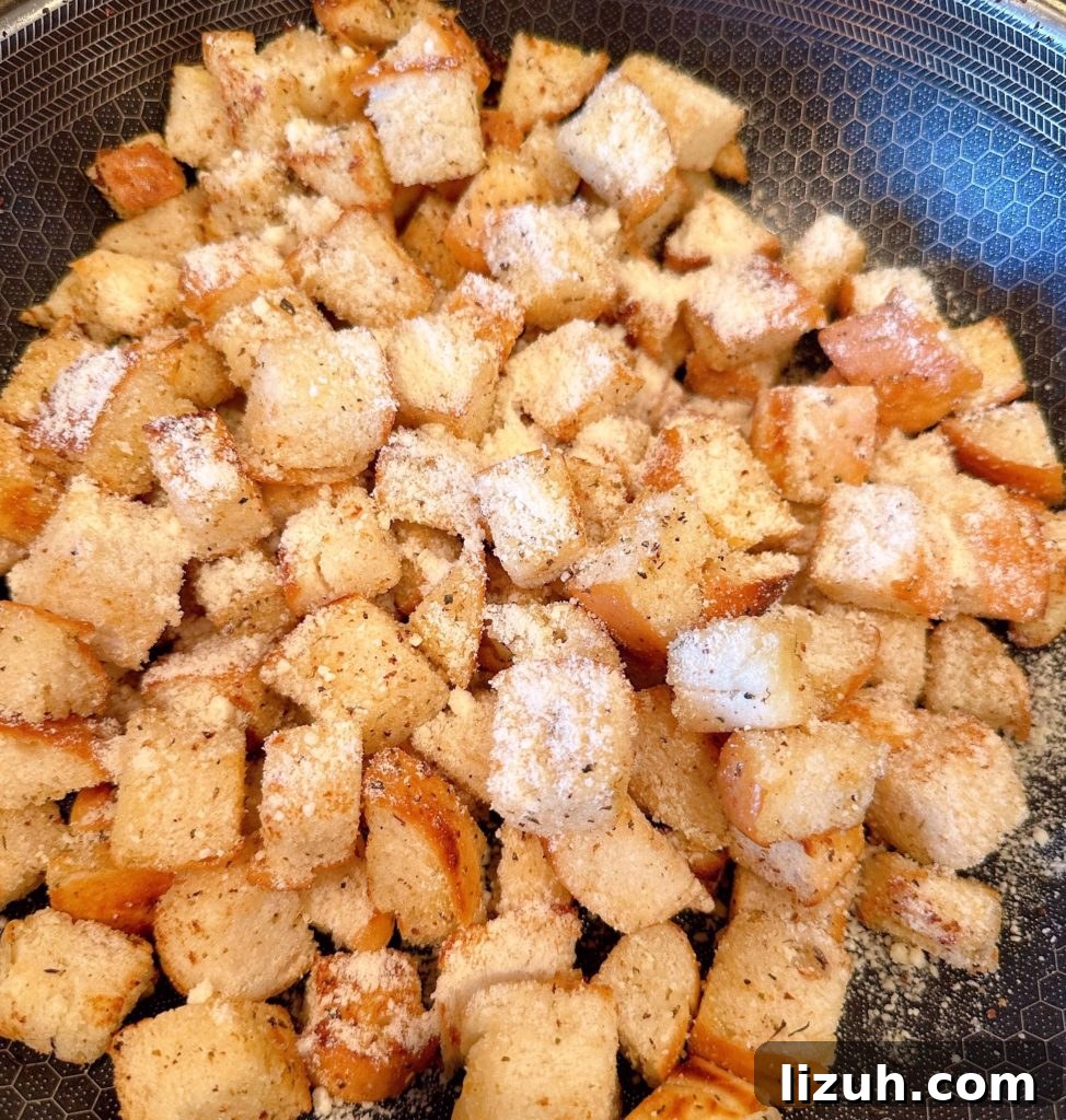 Skillet Croutons from Scratch: Crispy Homemade Recipe 6 Croutons in the skillet toasted a golden brown with Parmesan Cheese.