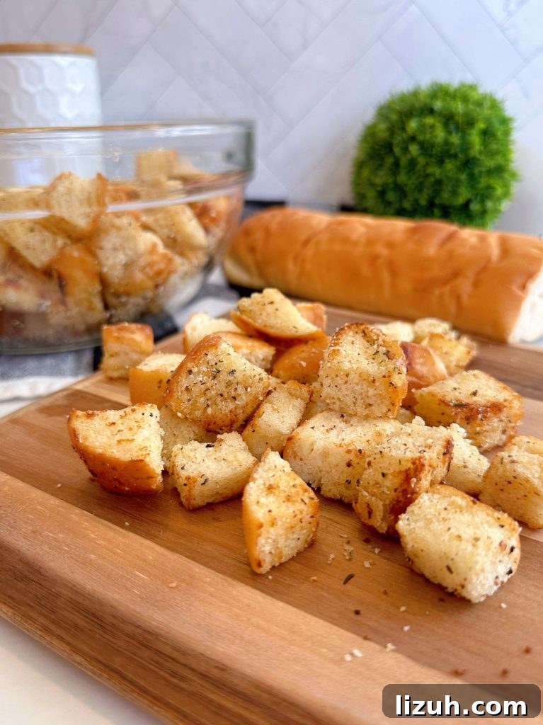 Skillet Croutons from Scratch: Crispy Homemade Recipe 7 Homemade Skillet Croutons in a bowl and on a cutting board.