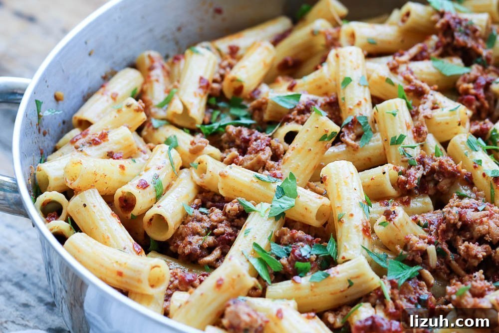 Sun-Dried Tomato Chicken Pasta with Garlic and Parmesan 15 close up of pasta in pan