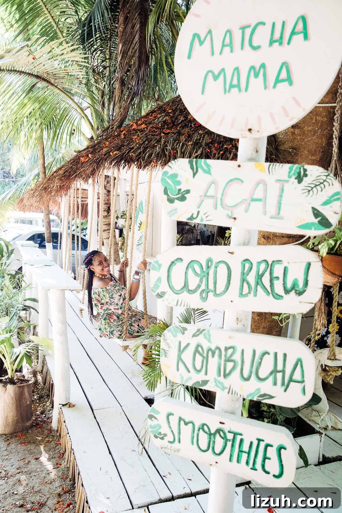Tulum Travel Guide: Top Food, Where to Stay & Things to Do 2 Jessica on a swing under palm trees.