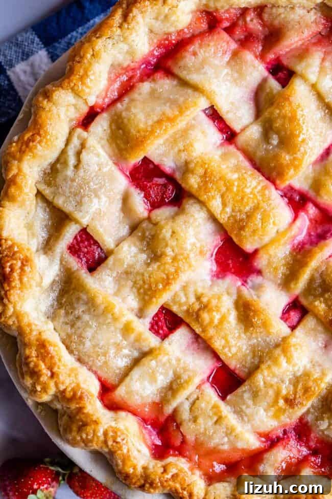 close up overhead shot of strawberry pie with weaved lattice crust