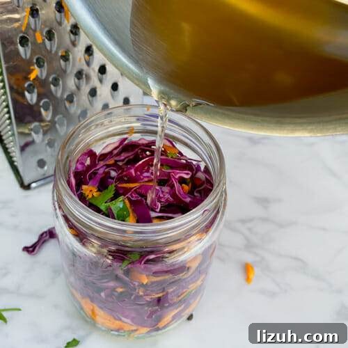 pouring brine on top of cabbage