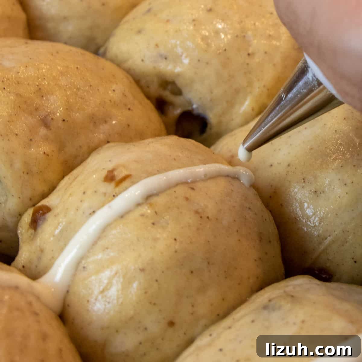 Piping the cross with flour and water paste.