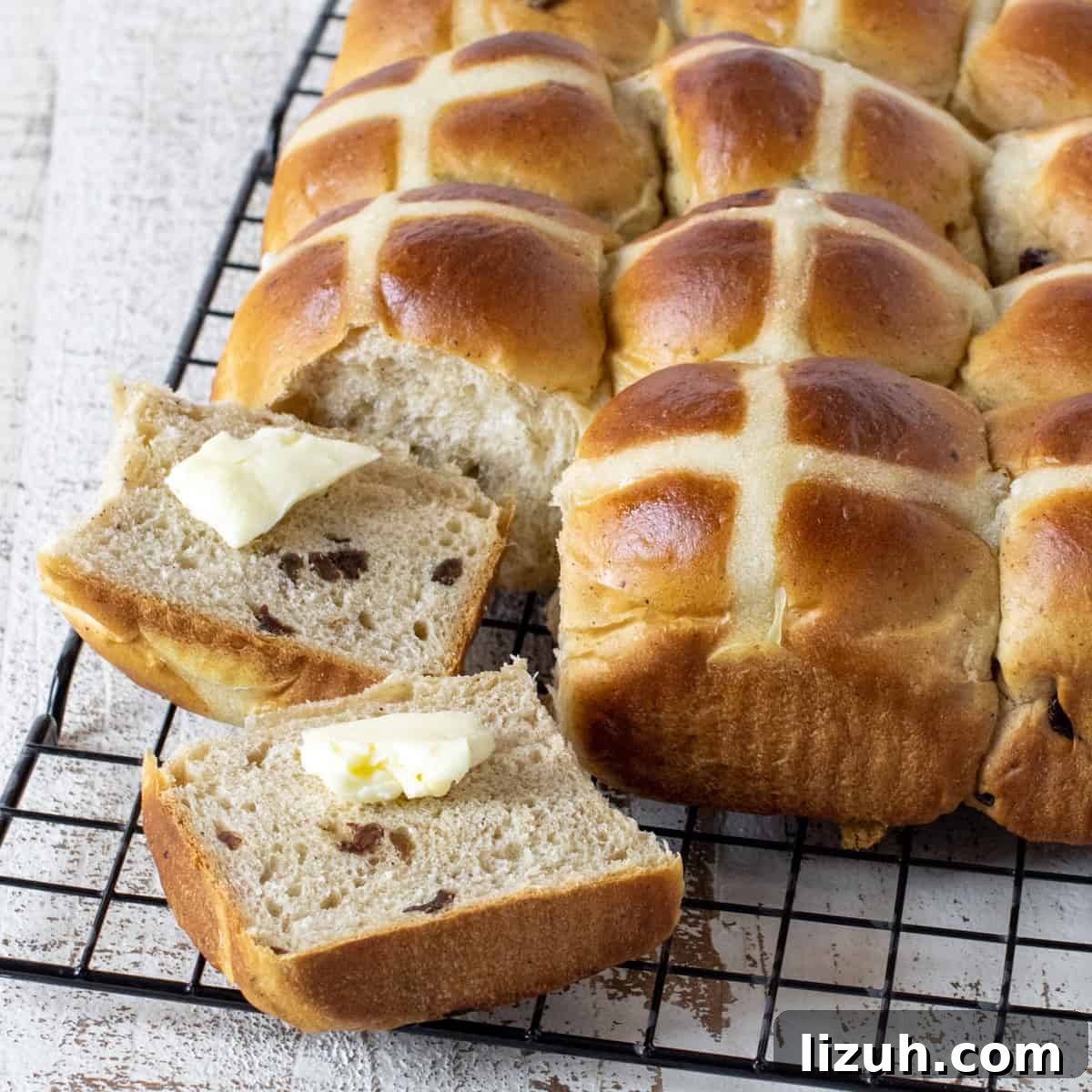 Sliced hot cross bun with butter.