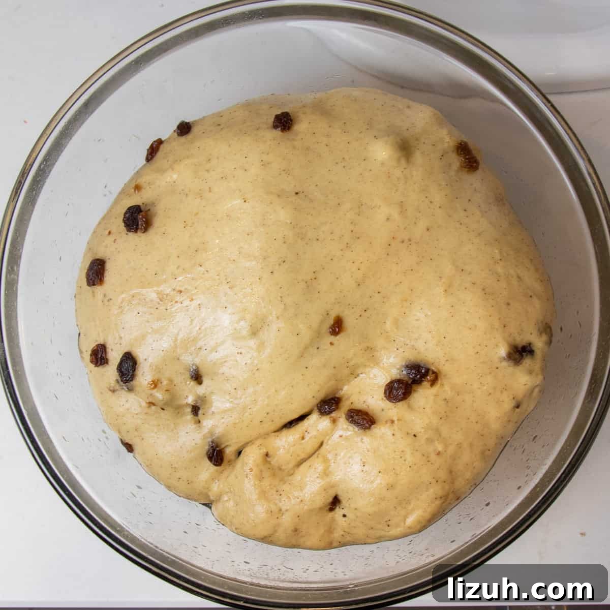 Risen dough in a glass bowl.