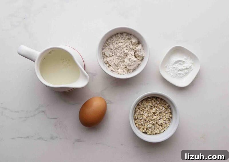 Single-Serve Oatmeal Protein Pancakes: Quick High-Protein Recipe 3 Oats, baking powder, egg, and milk on a table.
