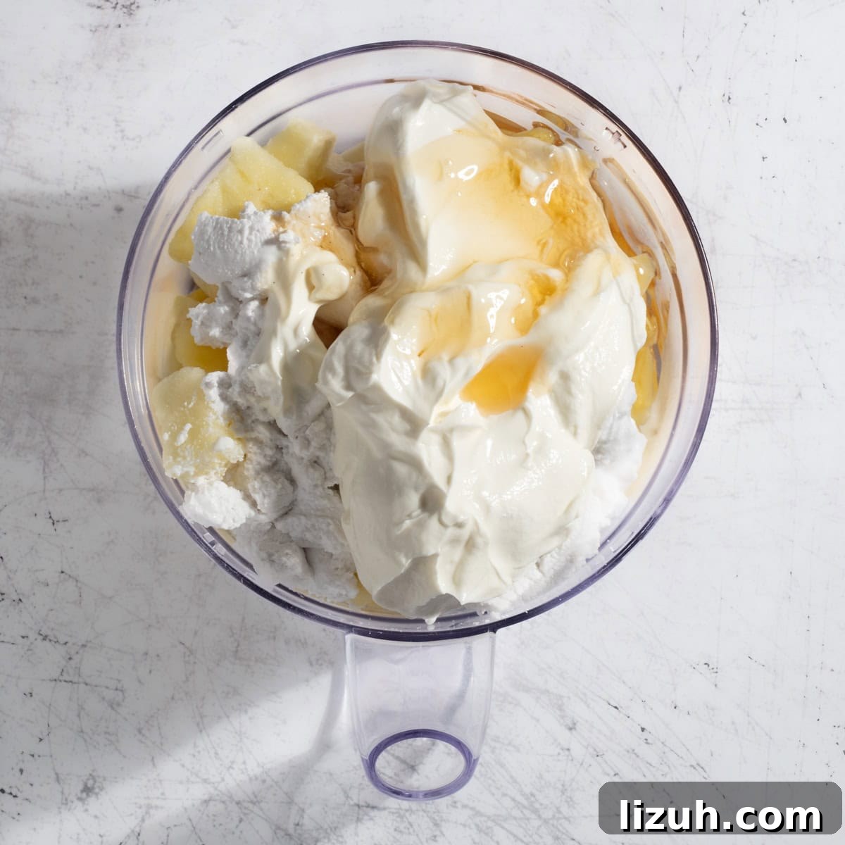 Ultra-Creamy Piña Colada Smoothie — No Banana, No Ice 8 All the ingredients for the pina colada smoothie in a blender.