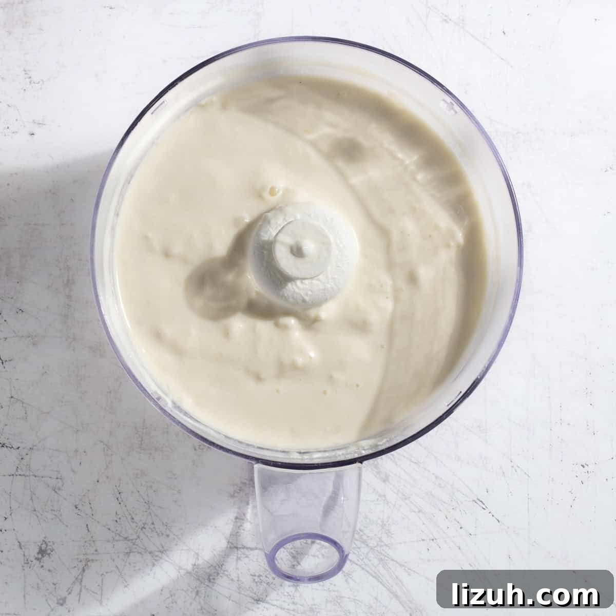 Ultra-Creamy Piña Colada Smoothie — No Banana, No Ice 9 A complete pina colada smoothie in a blender.