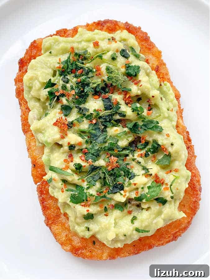 Air Fryer Frozen Hash Browns: Crispy in 15 Minutes 4 air fryer hashbrown potato pattie topped with mashed avocado and fresh herbs
