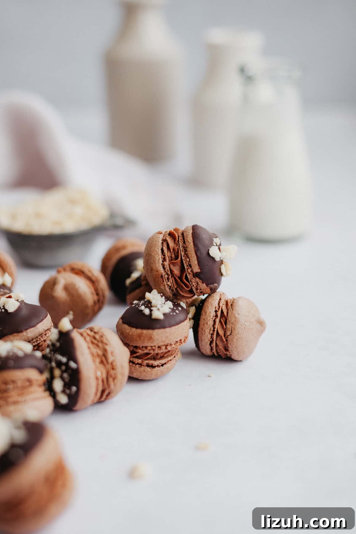 Nutella-Filled Chocolate Macarons: Classic French Cookie Recipe 3 six nutella macarons on a marble counter, there is a small milk jug behind