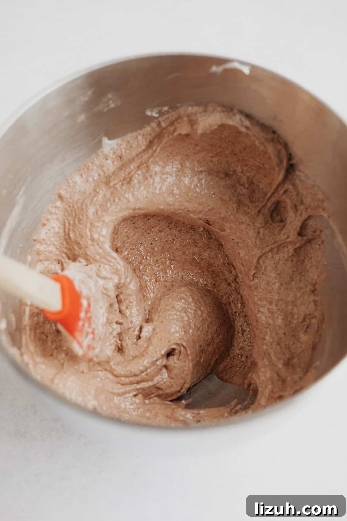 Nutella-Filled Chocolate Macarons: Classic French Cookie Recipe 8 Nutella macaron batter in a large silver bowl