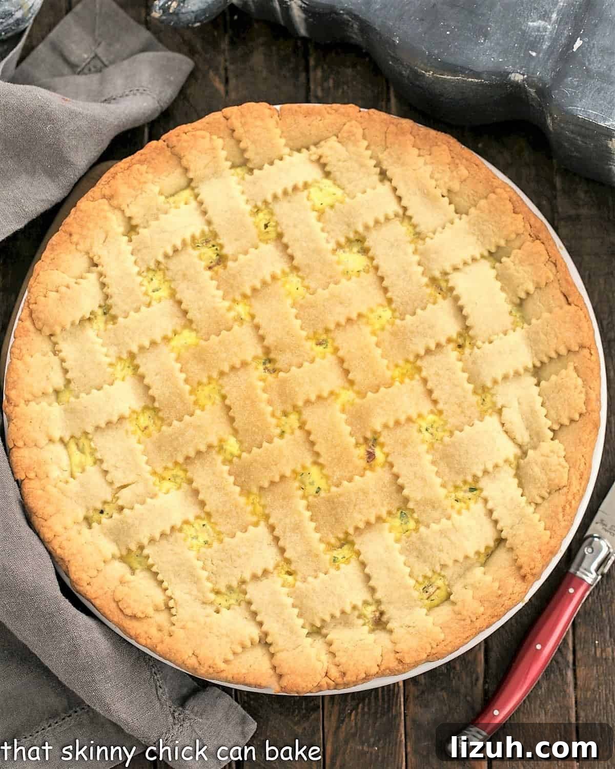 Classic Italian Pizza Rustica Recipe: Savory Rustic Pie Guide 3 Overhead view of Pizza Rustica next to a red handled knife.
