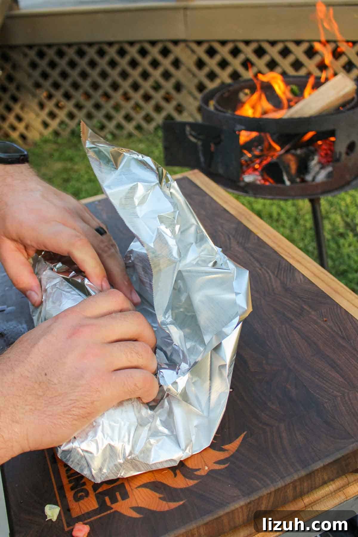 Wrapping the Animal Style Cheesesteak in foil.