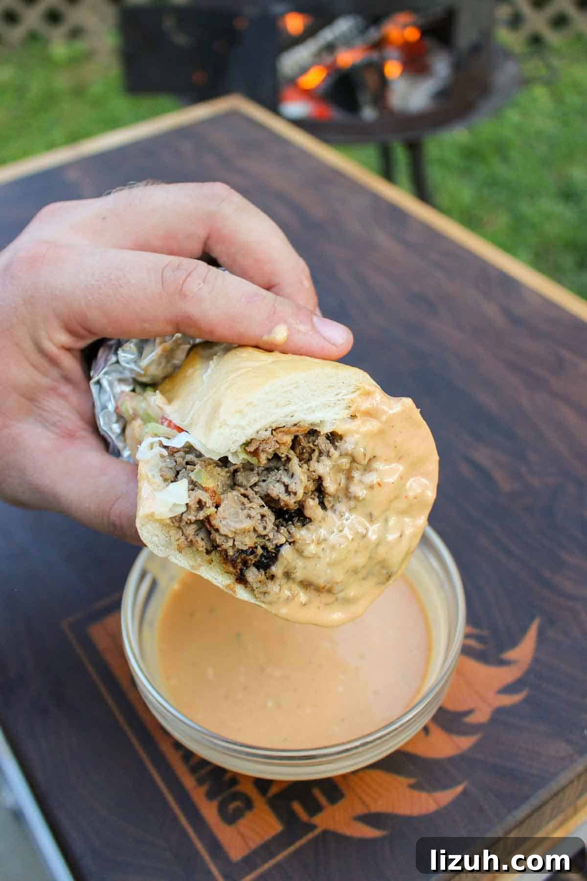 The cheesesteak after being dipped in the sauce.