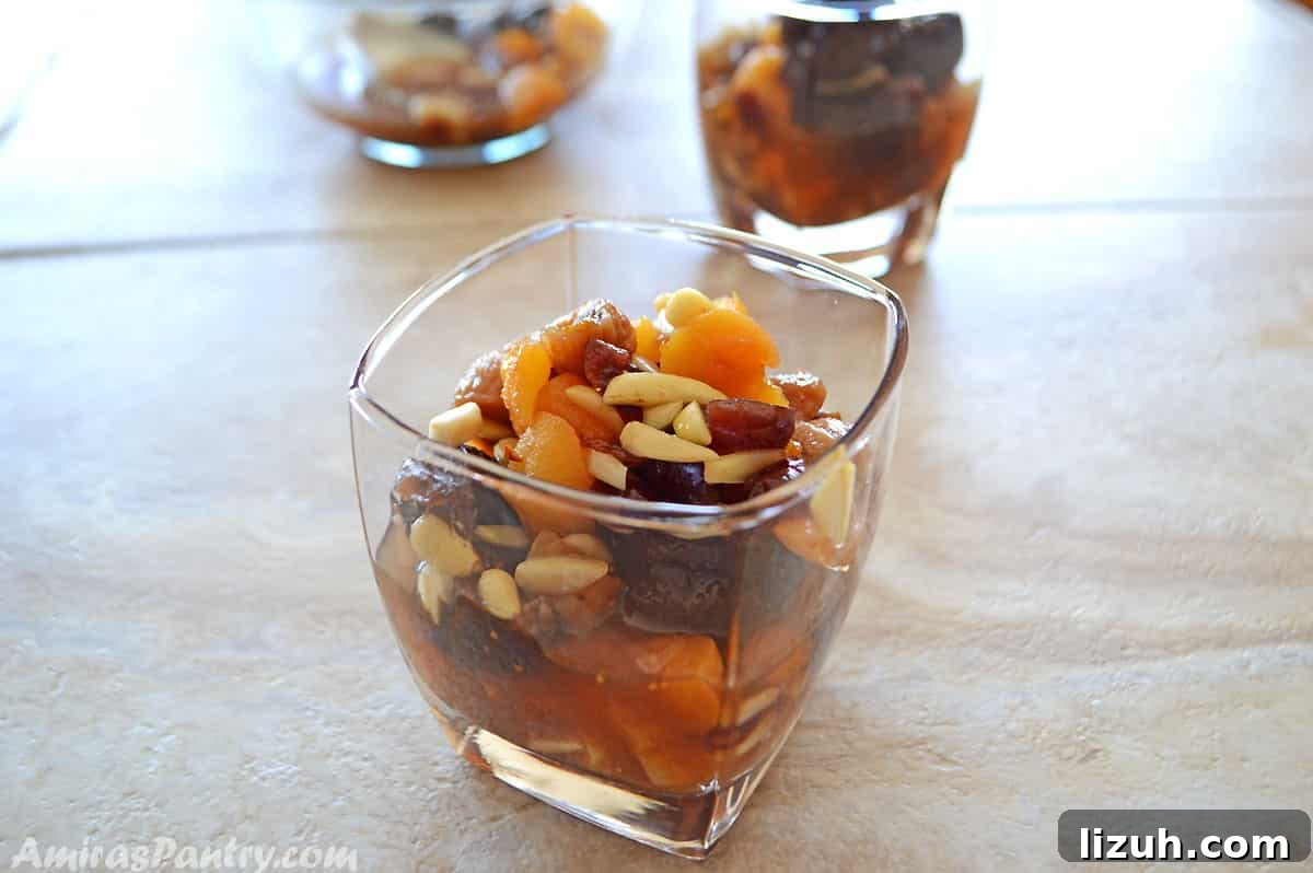 Khoshaf: How to Make Traditional Middle Eastern Dried Fruit Compote 6 A cup of dried fruits compote placed on a tile table
