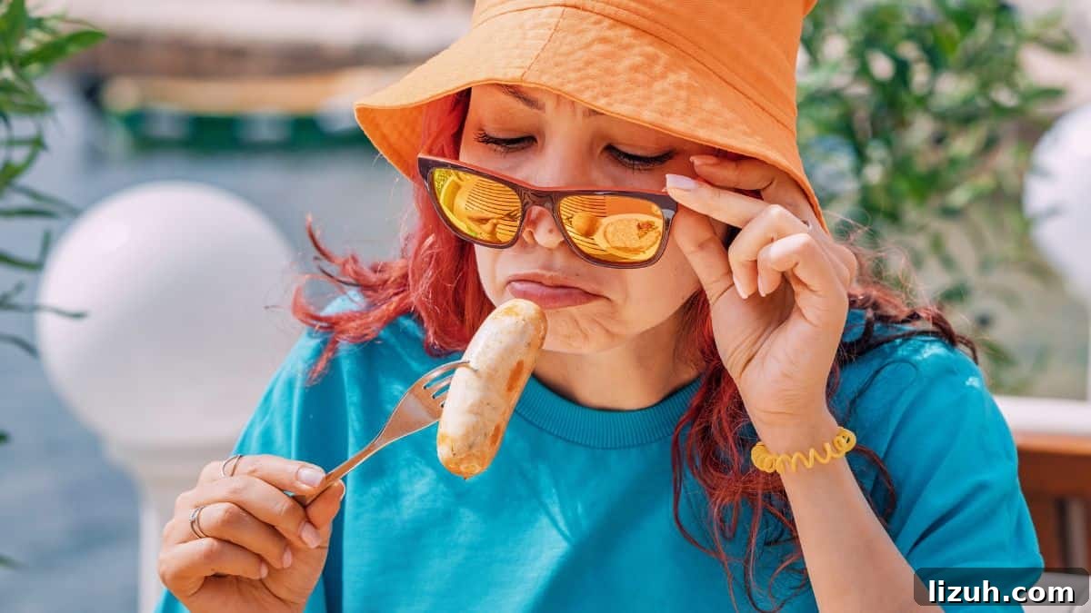 15 Foods That Feel Awkward to Eat in Front of Others 8 disgusted woman looking at sausage