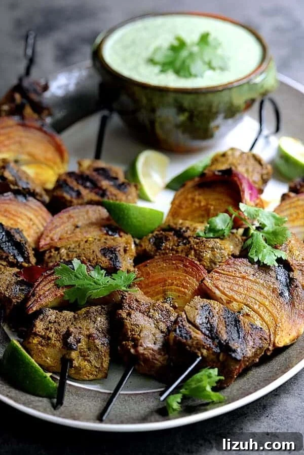 Indian Beef Kabobs with Cilantro Coconut Sauce recipe 10 Four Indian-Style Beef Kabobs with Cilantro - Coconut Sauce on a gray-rimmed platter.