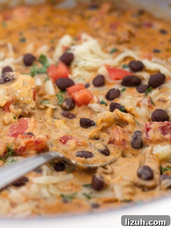 Pepperoni Pizza Cheese Ball Game-Day Appetizer 9 Velveeta queso in a skillet with toppings.