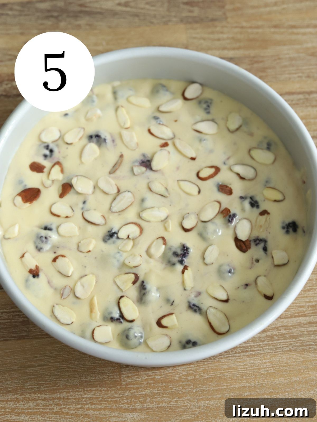 Moist Blackberry Almond Cake Recipe with Crisp Almond Topping 8 Cake batter in a pan with almonds on top.