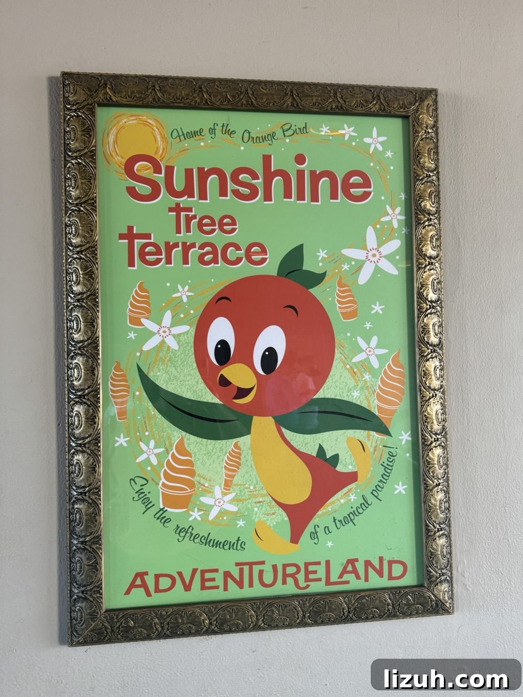 A poster for Sunshine Terrace in Adventureland with a cartoon bird surrounded by orange ice cream swirls