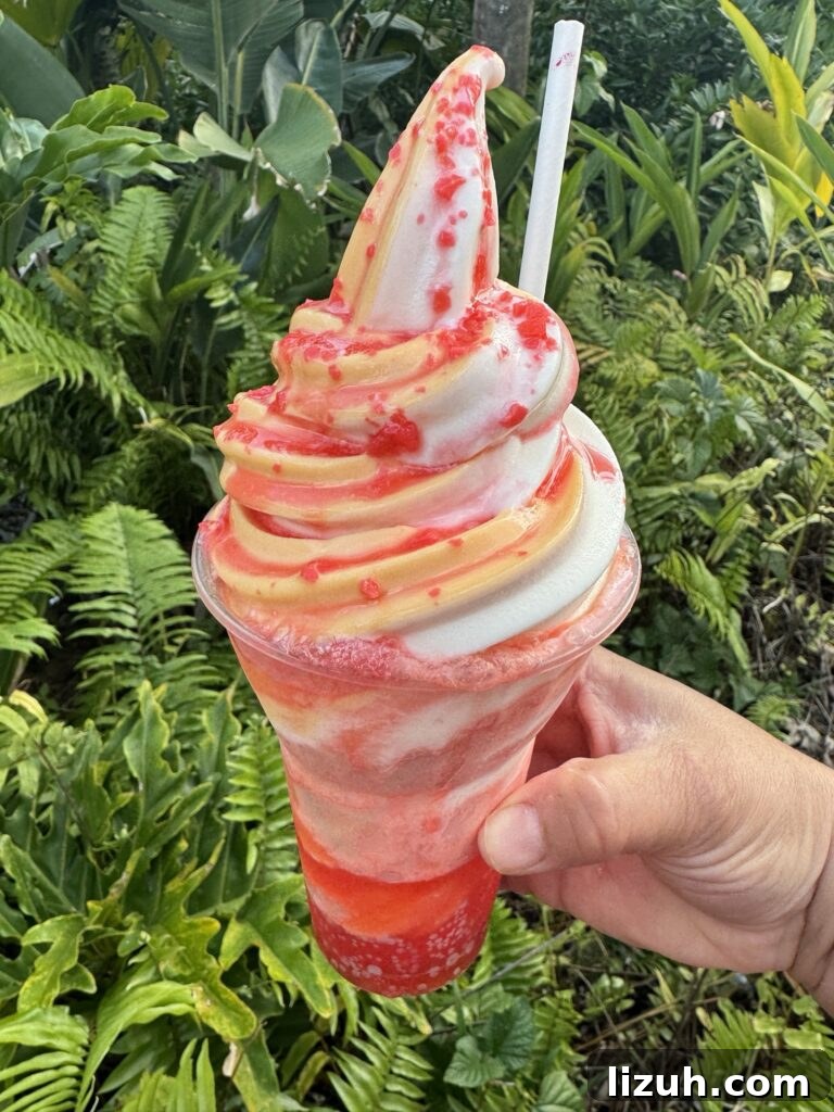 An yellow and white soft serve ice cream swirl float in a red fizzy liquid