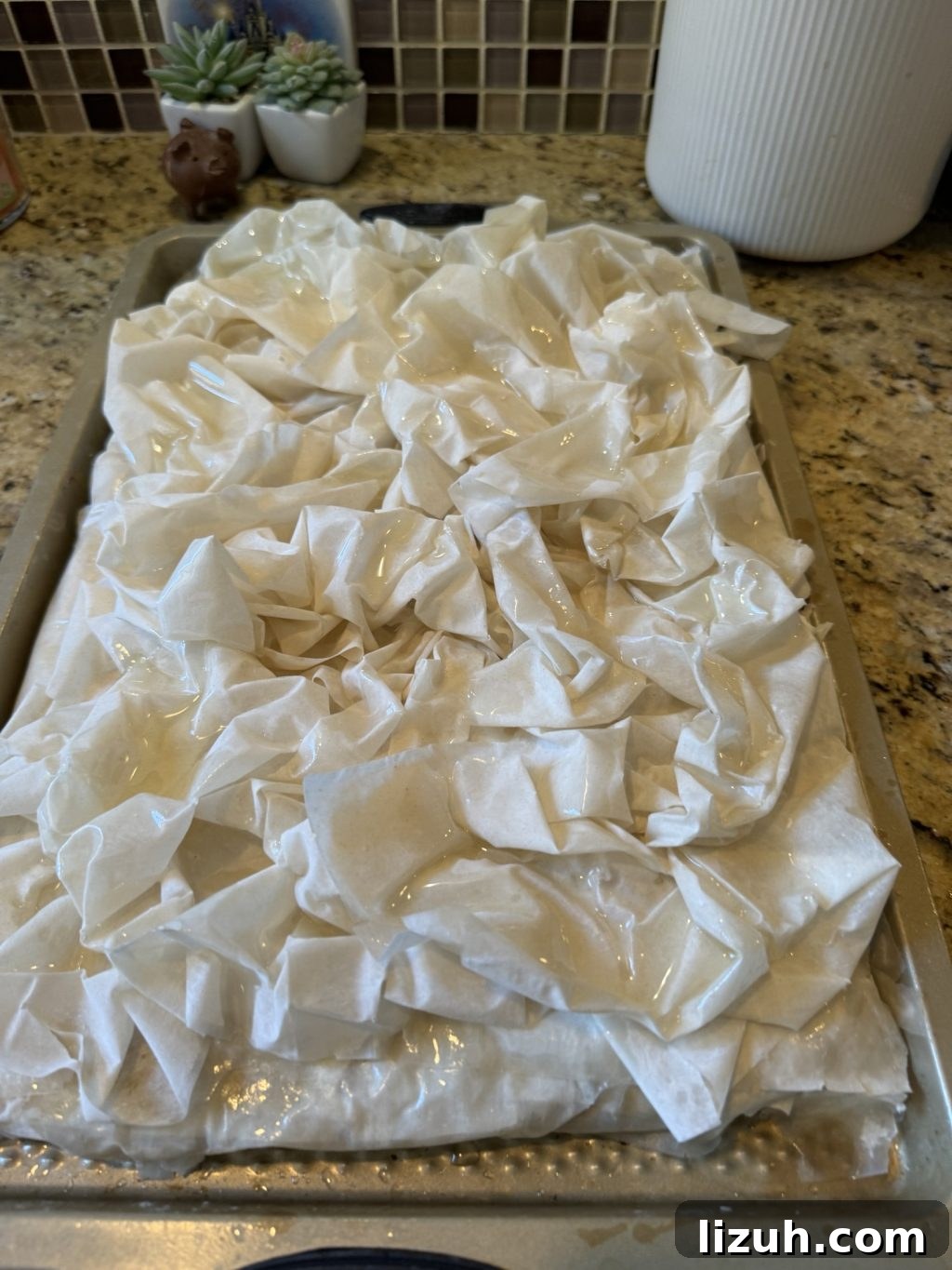 A layer of scrunched up Phyllo dough has been placed on the rest of the dough