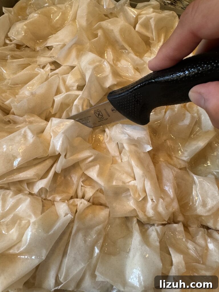 A knife slicing into the prebaked cheeseburger squares