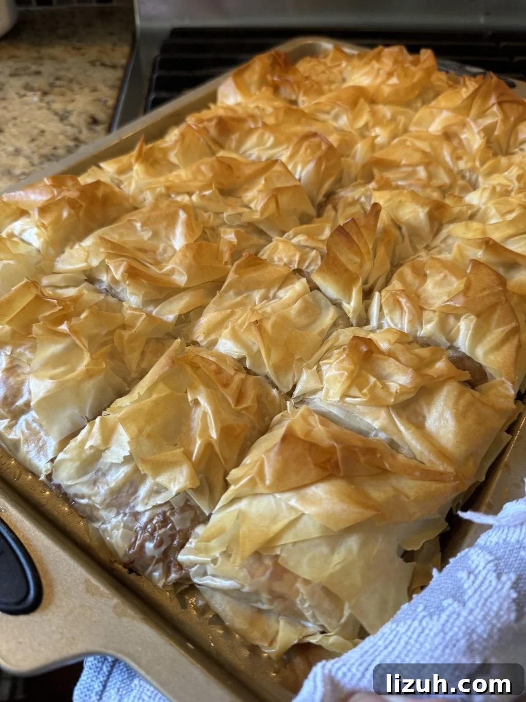 The finished cheeseburger spring roll squares after being removed from the oven