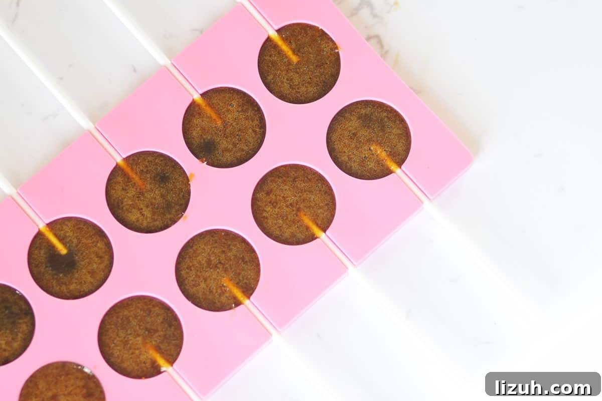 Homemade Honey Lollipops: A Sugar-Free Recipe You’ll Love 6 a lollipop mold with lollipop sticks and melted honey poured in them